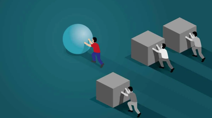 An image of three people pushing boxes and one person pushing a sphere